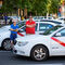 Una pareja de taxistas permanece esperando sobre sus vehículos durante la tercera jornada en la Castellana.