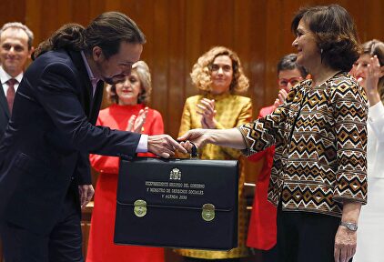 Iglesias recibe la cartera de manos de Calvo. |  EFE