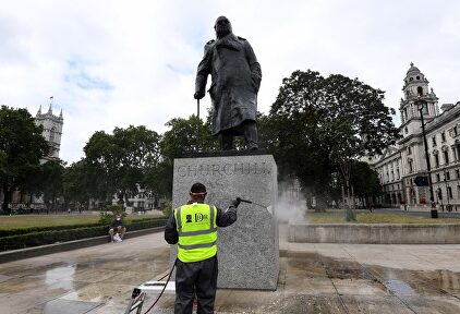 Un operario limpia de pintadas, este martes, una estatua de Winston Churchill en Londres. | EFE