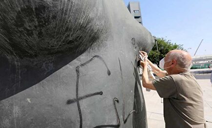 Antonio López repara su escultura. | Ayuntamiento de Coslada