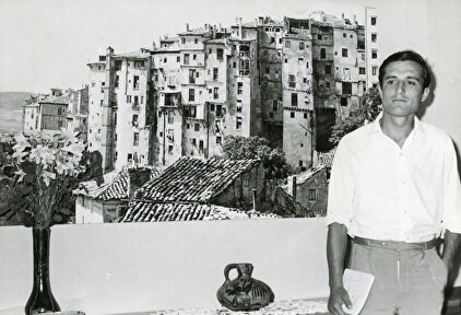 Raúl del Pozo, de joven, junto a una enorme imagen de Cuenca. | Archivo Raúl del Pozo