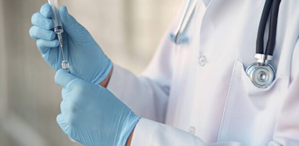 person in white long sleeve shirt holding injection | Pexels/CC0/Gustavo Fring