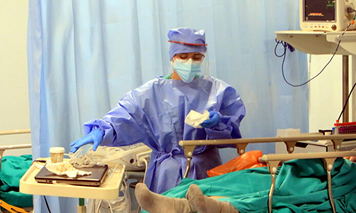 Un sanitario atiende a un enfermo en el área de coronavirus de un hospital. | EFE