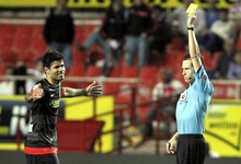 El rbitro Gonzlez Gonzlez muestra la amarilla a Diego Costa durante el Sevilla-Atltico de Madrid. | Cordon Press