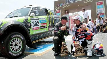Peterhansel (i) y Despres celebran sus triunfos en el podio final de Santiago. | EFE